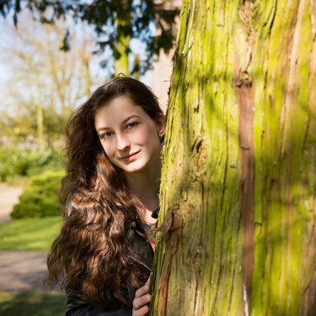Girl behind a tree