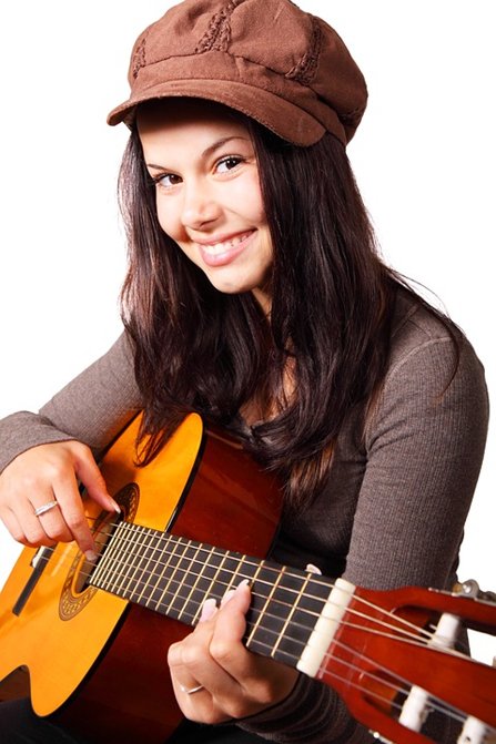 Happy young woman with a guitar