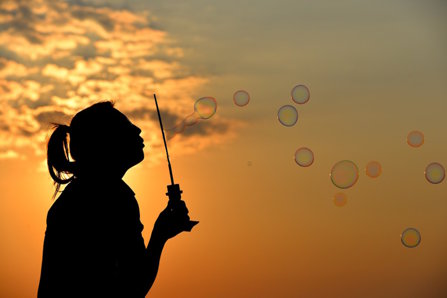 Silhouette woman with soap bubble