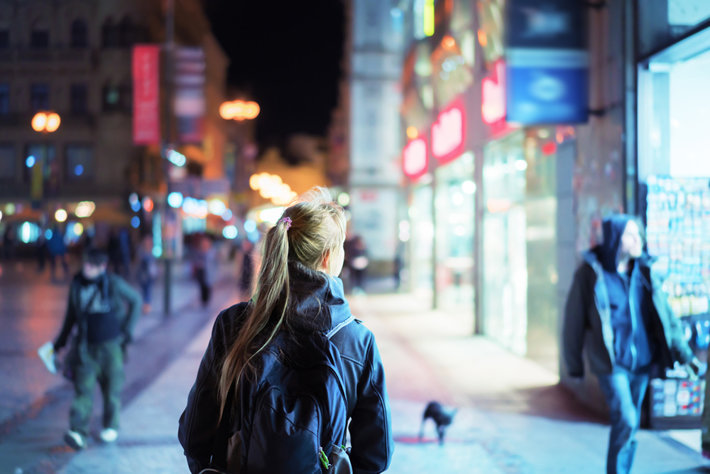 Woman walking in the night European city