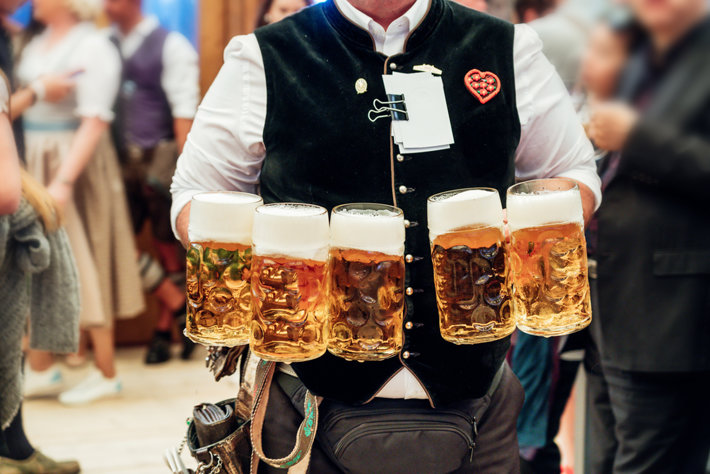 Waiter carrying a beer