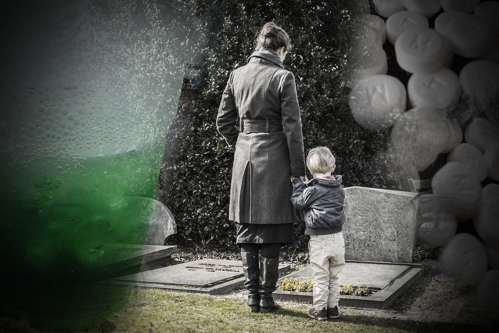 Mother with son standing at the grave of the methadone victim.
